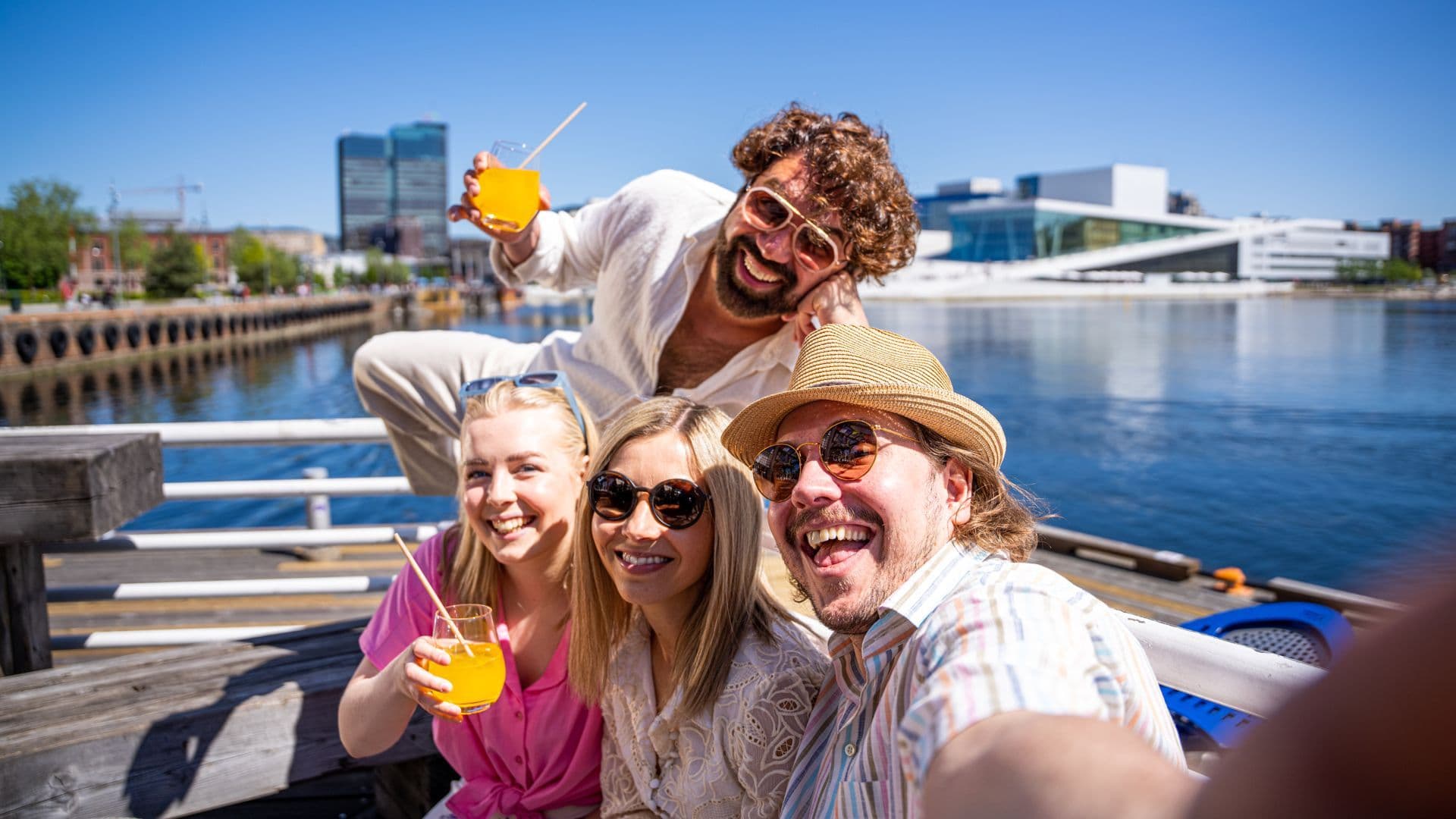 Friends taking selfie at Oslo Opera House on sunny day - iconic Norwegian architecture experience
