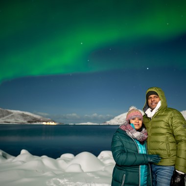 Couple on a Northern lights safari camp in Tromsø, Norway