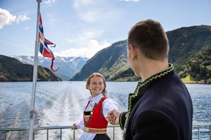 Wearing Norwegian national dress "bunad" on the Sognefjord in a nutshell tour - Norway