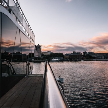 Dinner cruise on the Oslofjord with a silent hybrid boat - sunset over Oslo, Norway