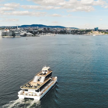 Dinner cruise on the Oslofjord with a silent hybrid boat - view towards Oslo, Norway