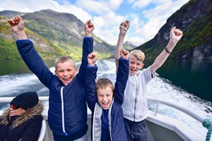 Happy boys on a trip - Fjord cruise on the Geirangerfjord from Geiranger, Norway